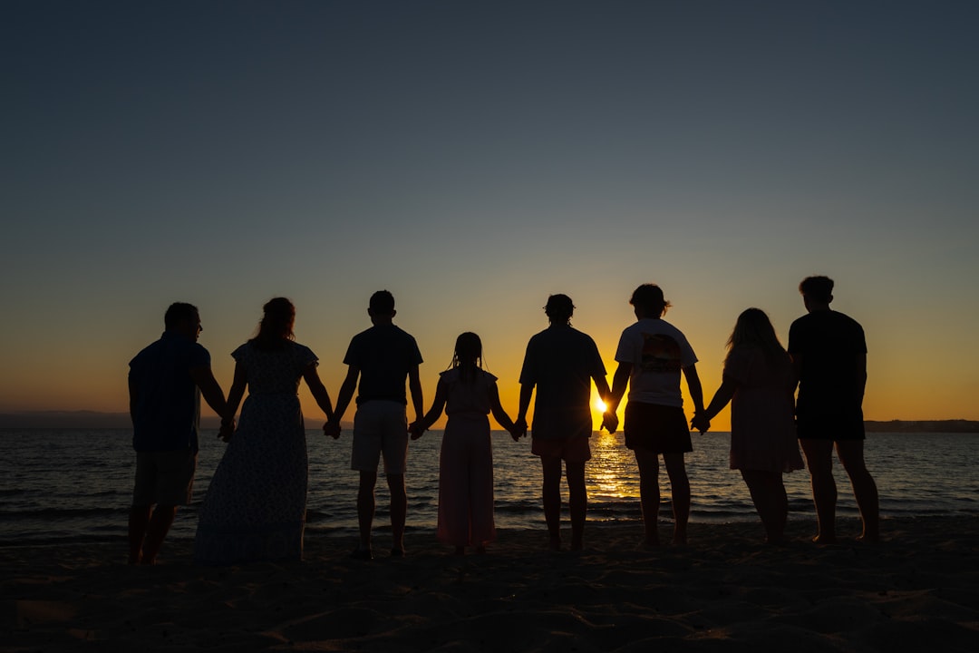Family photo against a sunset on a beach in Mexico