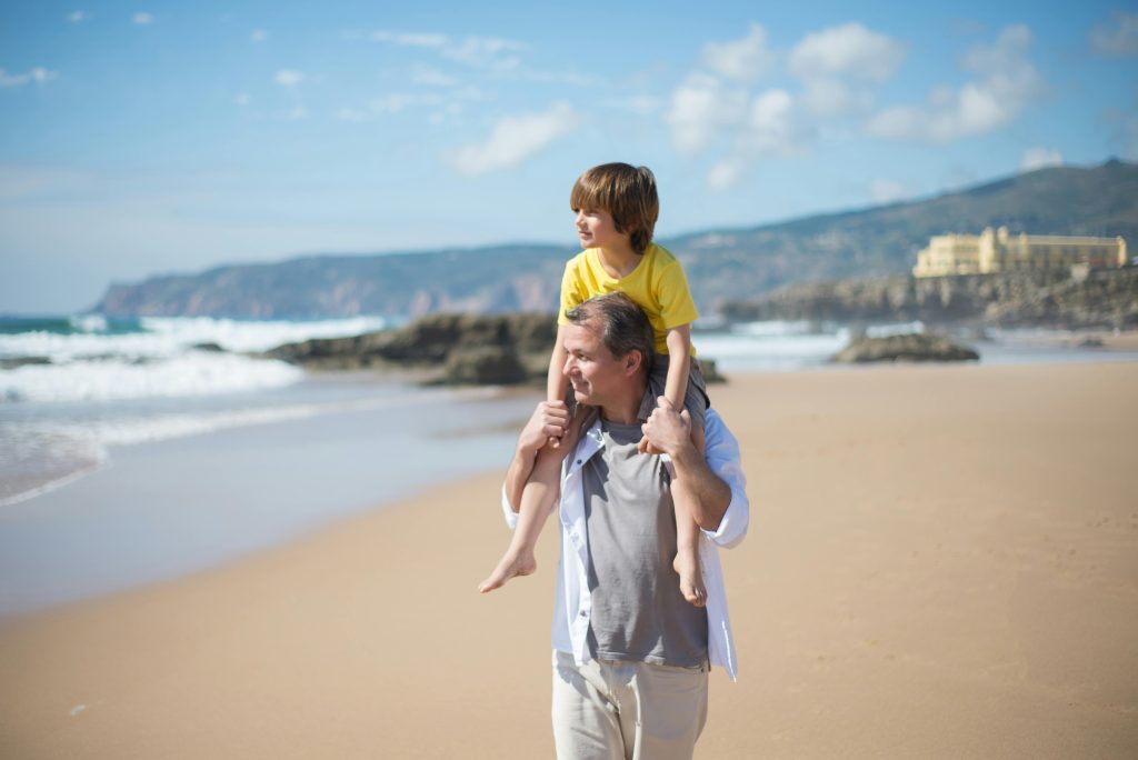 father and son walking on beach representing the work of a skilled child custody attorney