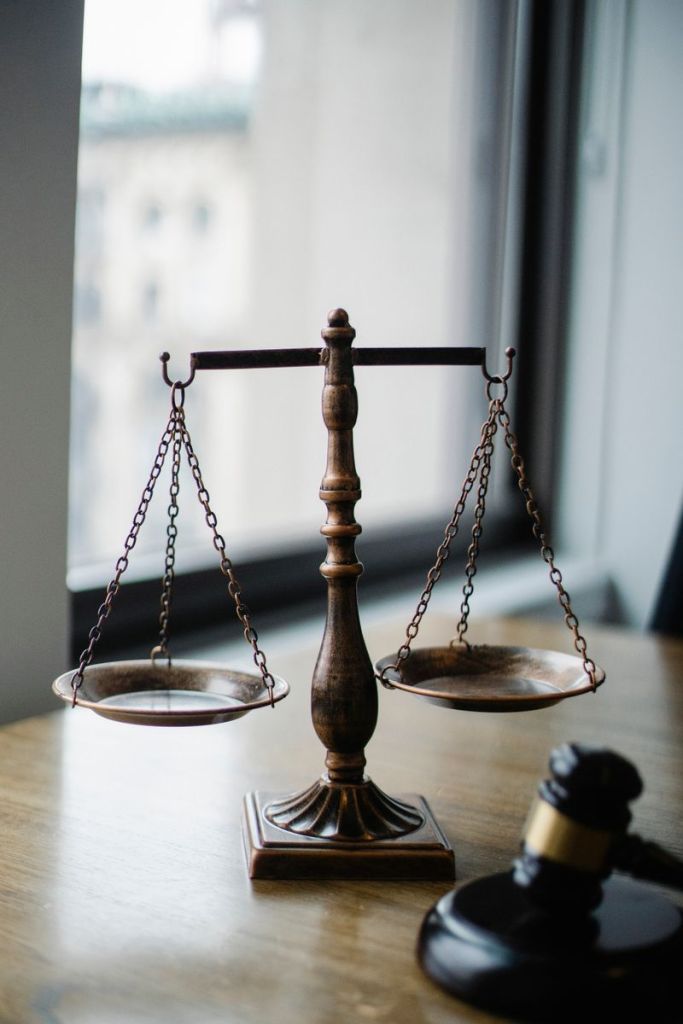 Decorative judgement scale and gavel placed on desk to represent justice in family law attorney fees